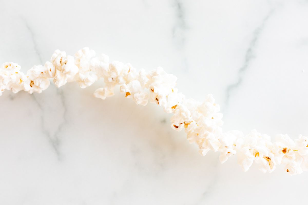 A popcorn string on a white marble surface.