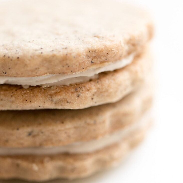 latte cookies with scalloped edge stacked on top of each other