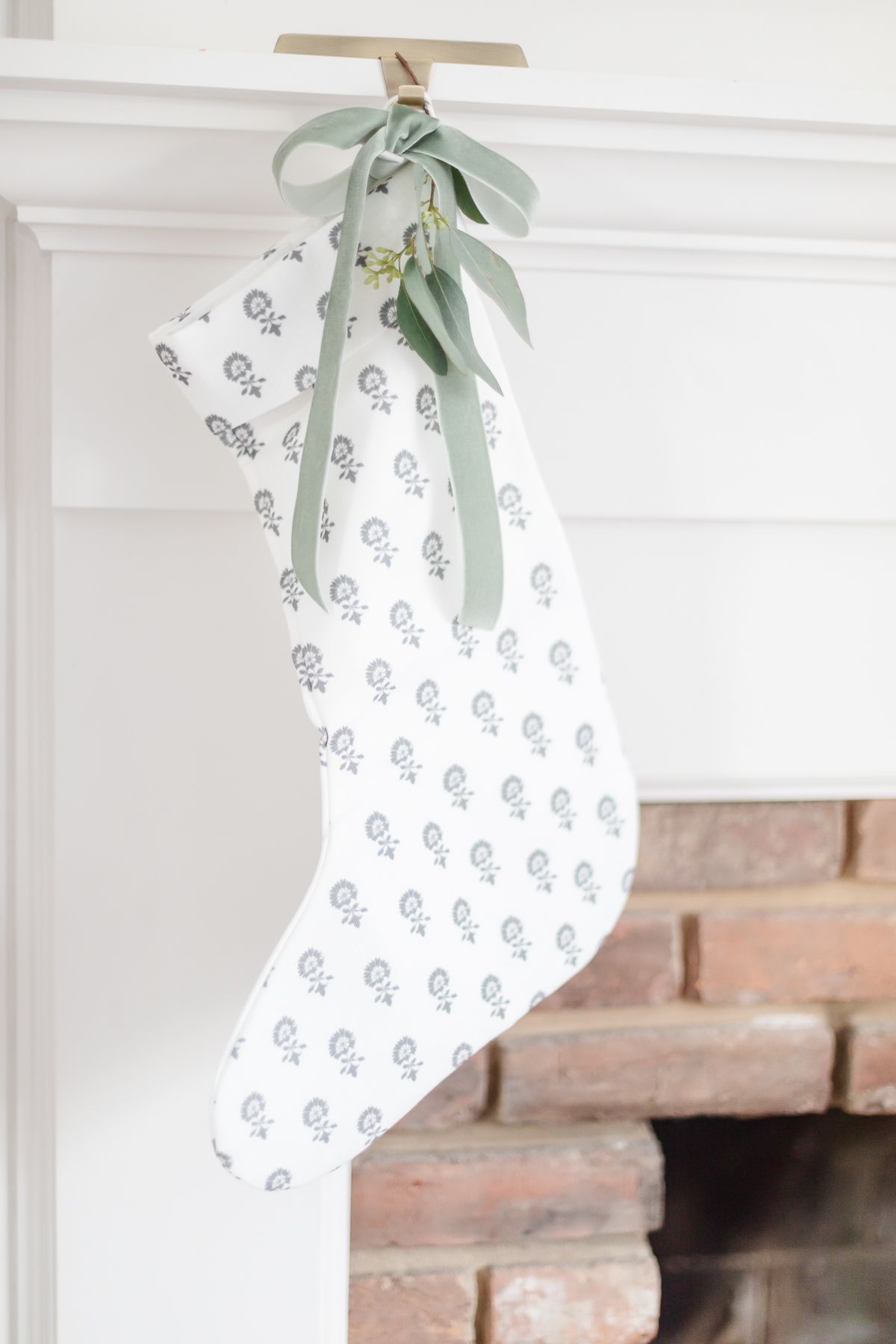 A block print stocking hung with a velvet green ribbon
