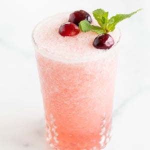A glass full of a pink toned frozen Mistletoe margarita