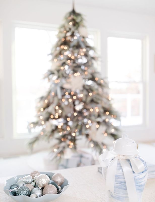 A christmas tree in a blue and white living room
