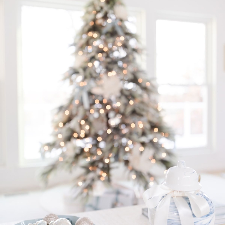 A christmas tree in a blue and white living room