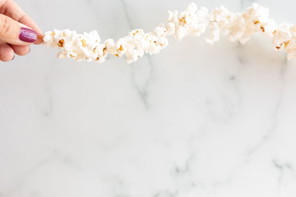 A string of popcorn garland on a white marble surface.