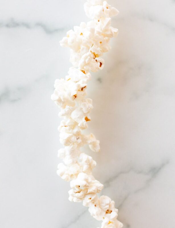 A string of popcorn garland on a white marble surface.