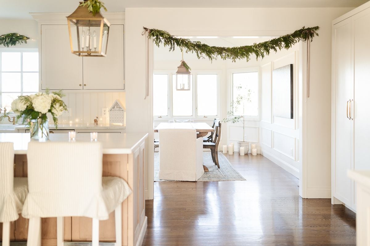 A garland hung with velvet ribbons in a white kitchen