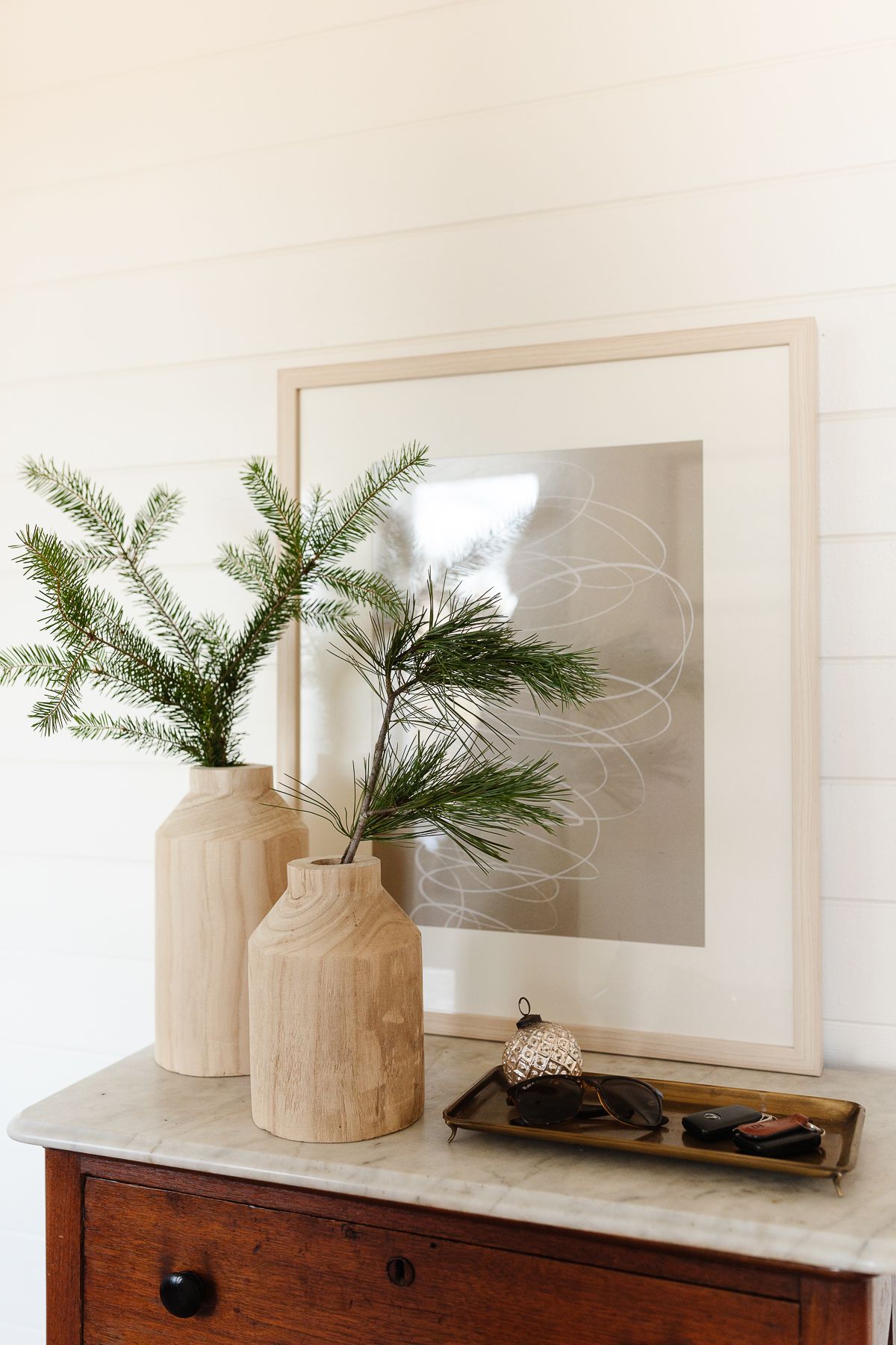 Traditional Christmas decor of evergreen branches in wooden vases