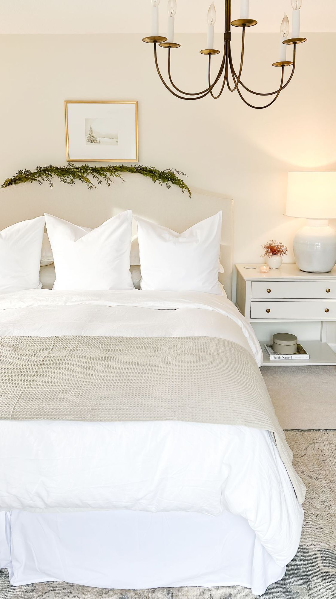 A primary bedroom with a garland and Traditional Christmas decorations