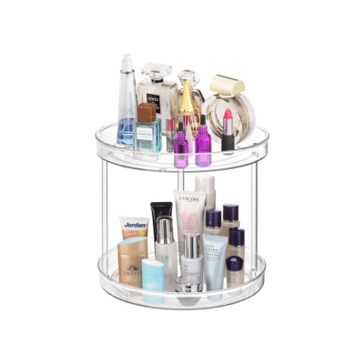 A clear round makeup organizer displaying cosmetics for bathroom organization.