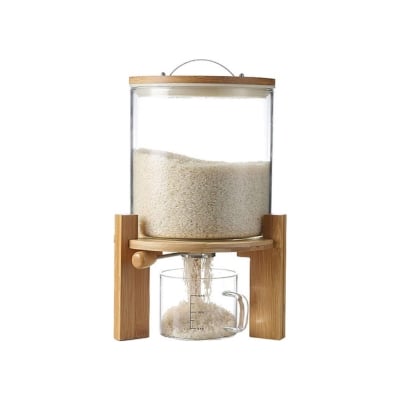 A kitchen counter organizer with a glass container on top for dispensing rice.