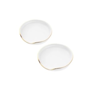 Two white plates with gold rims on a white background, perfect for kitchen counter organization.