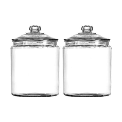 Two glass jars with lids, perfect for kitchen counter organization, placed on a clean white background.