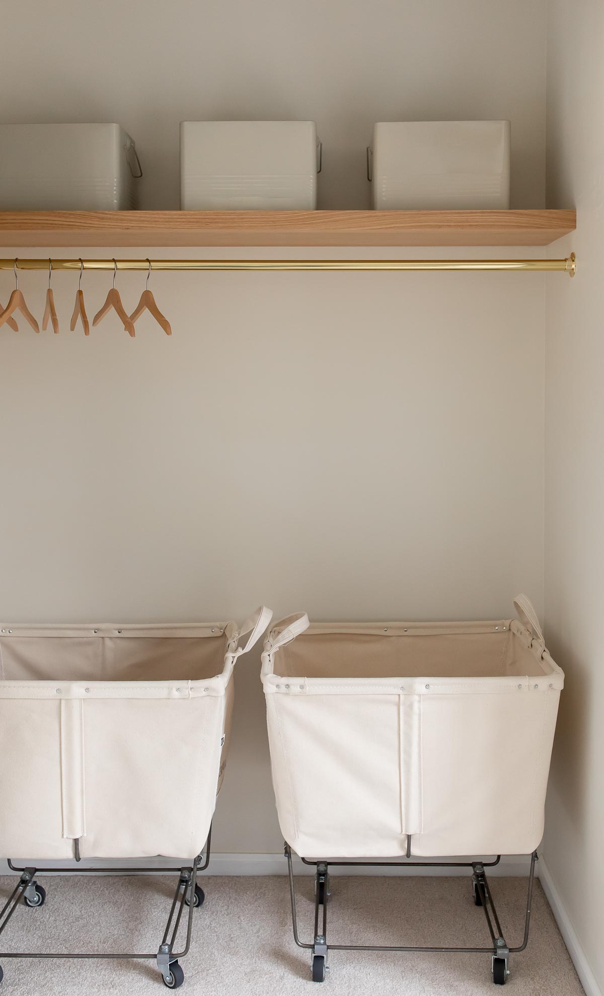 laundry room shelves with laundry carts below