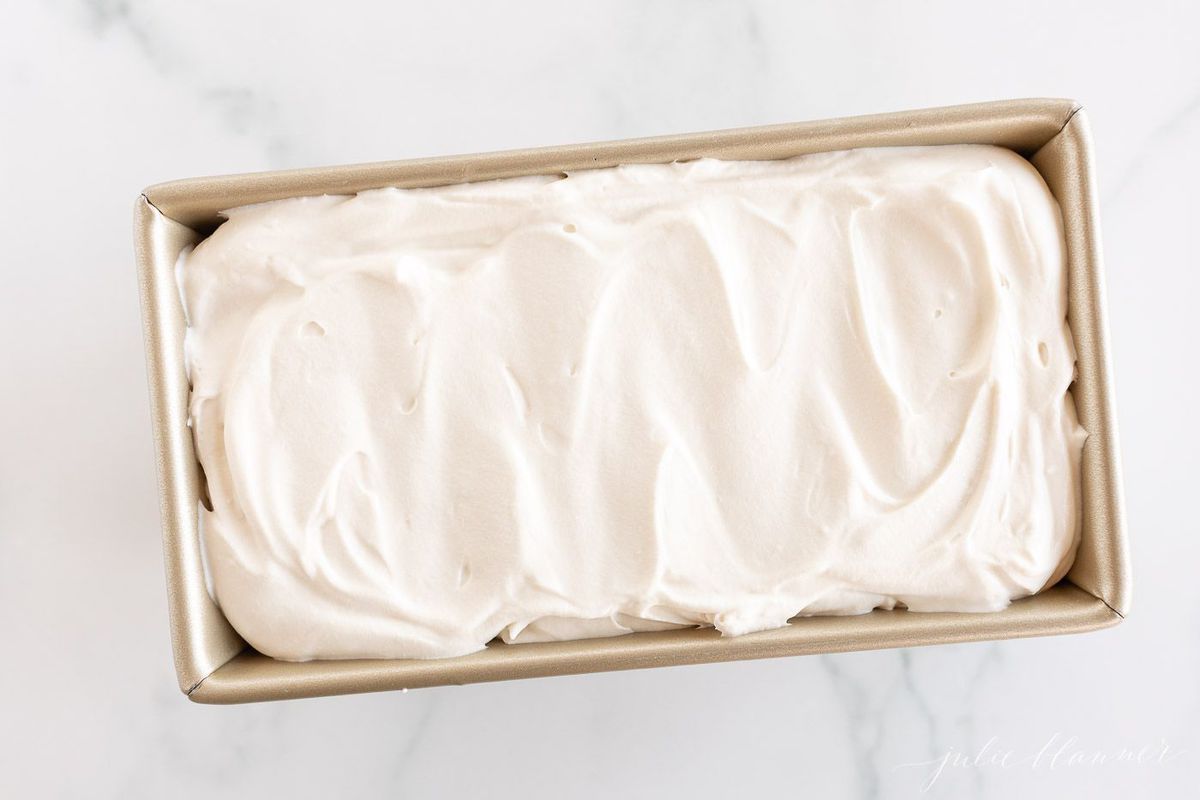 A gold loaf pan full of no churn mascarpone ice cream recipe