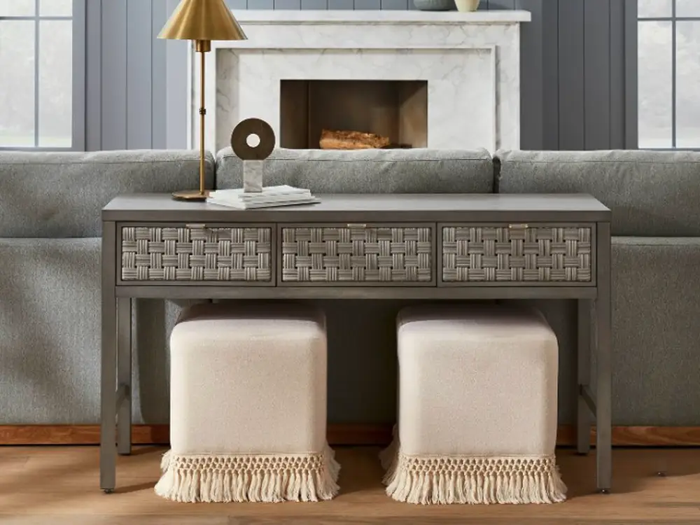 Fringed cream cubes under a sofa console table