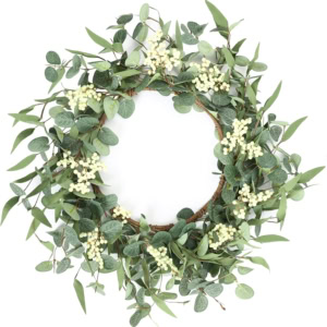 A round spring wreath made of green eucalyptus leaves and white berries sits elegantly on a plain white background.