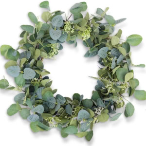 A circular eucalyptus spring wreath with green leaves densely arranged around the ring, featuring small white flowers interspersed throughout.