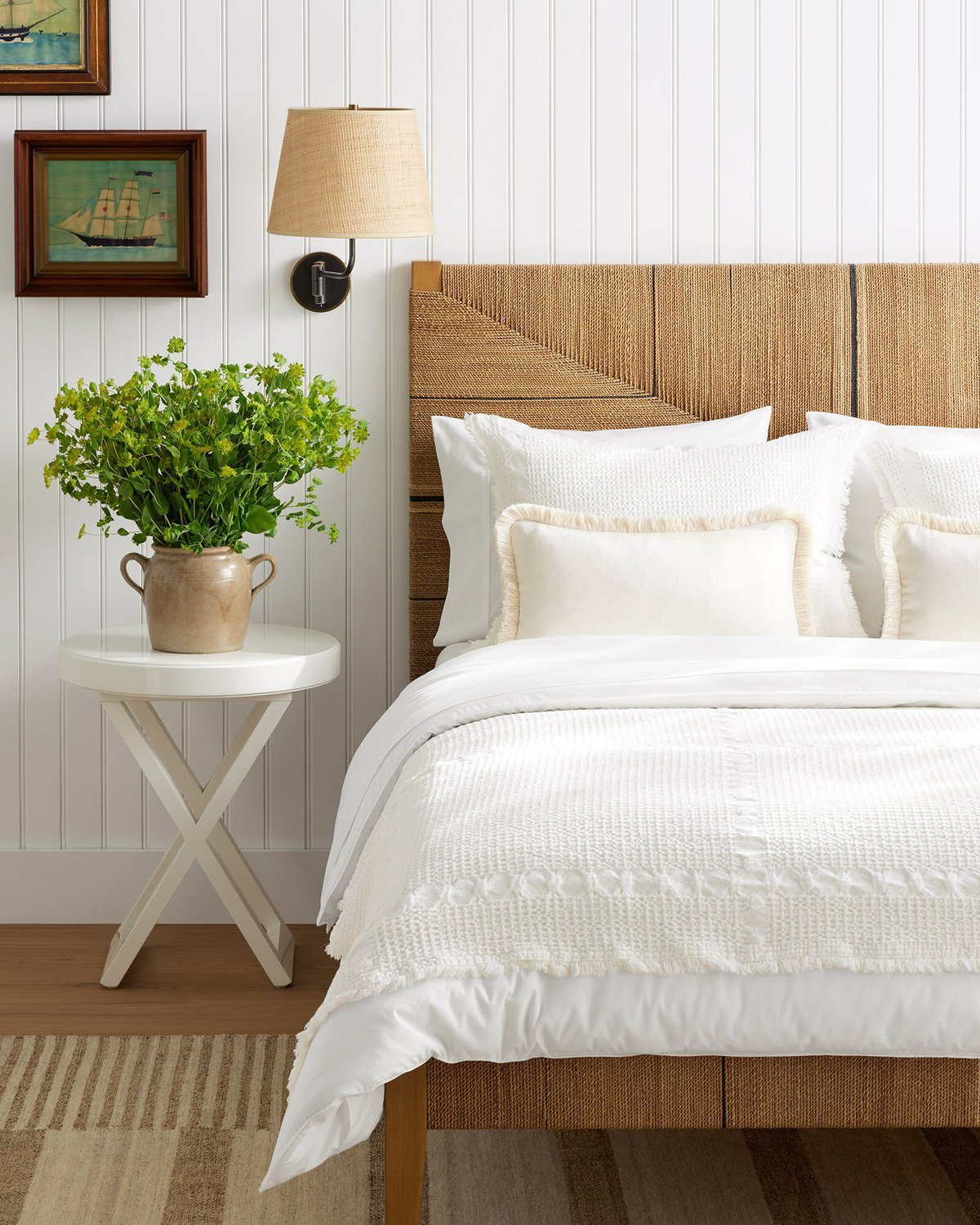 a bedroom with a rattan bed and a beadboard wall