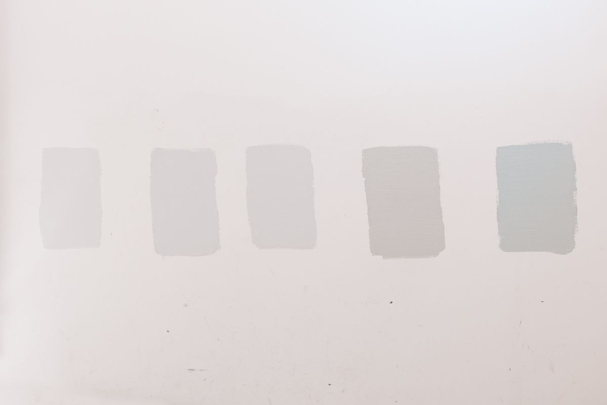 5 paint samples of blue gray paint colors on a white background