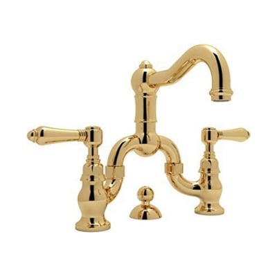 a gold faucet with two handles on a white background.
