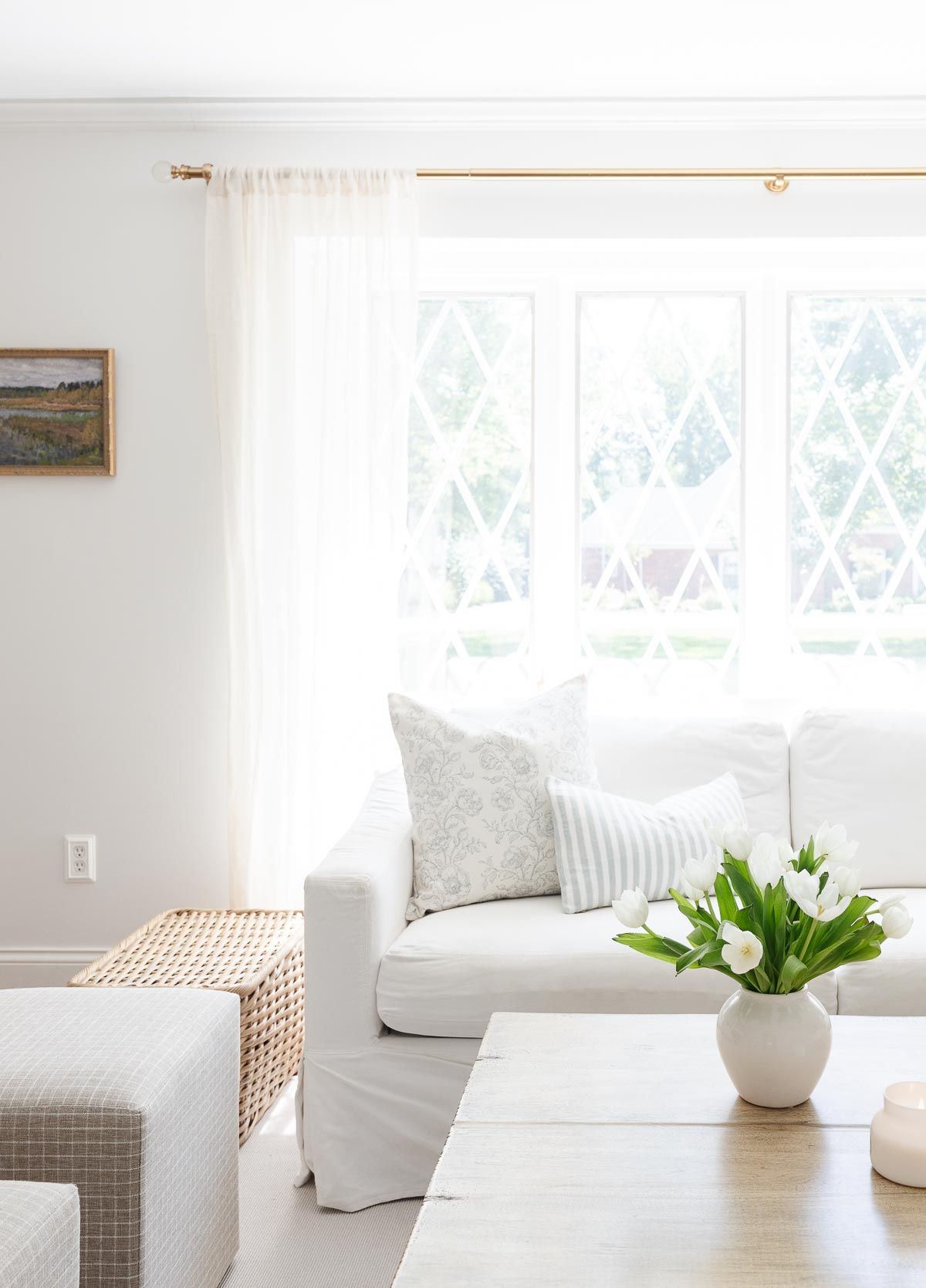 White sofa in a white living room with a wood coffee table