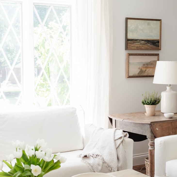 White sofa in a white living room with a wood coffee table