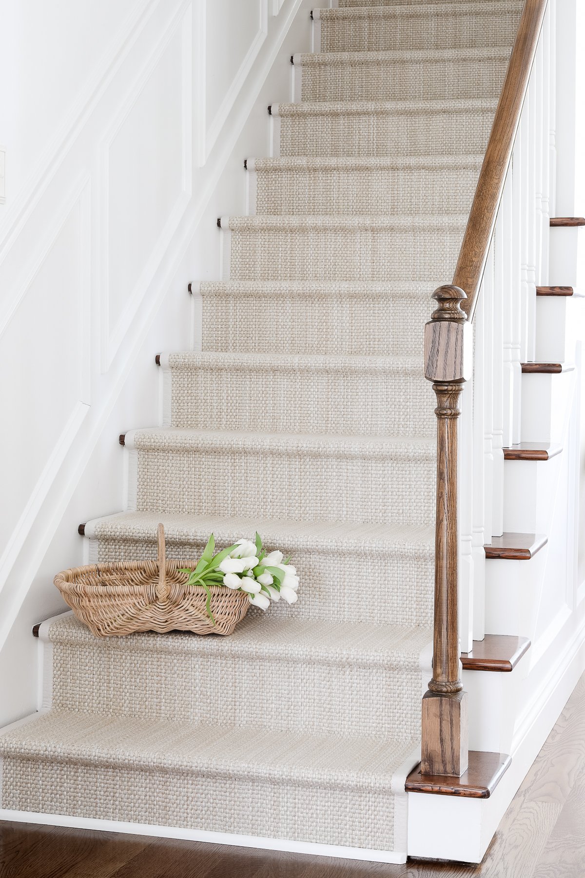 A wooden staircase with a diy stair runner.
