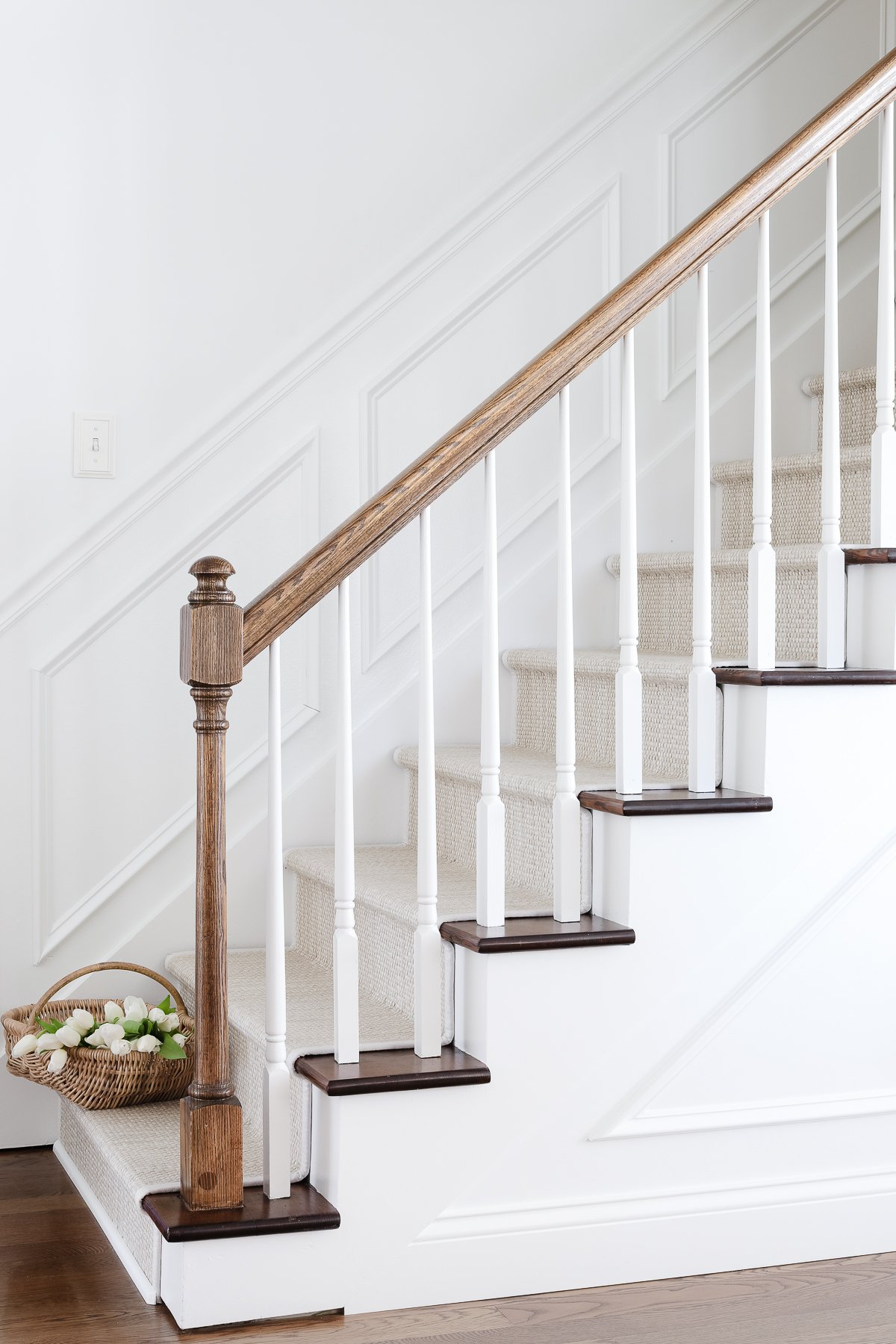 A wooden staircase with a diy stair runner.