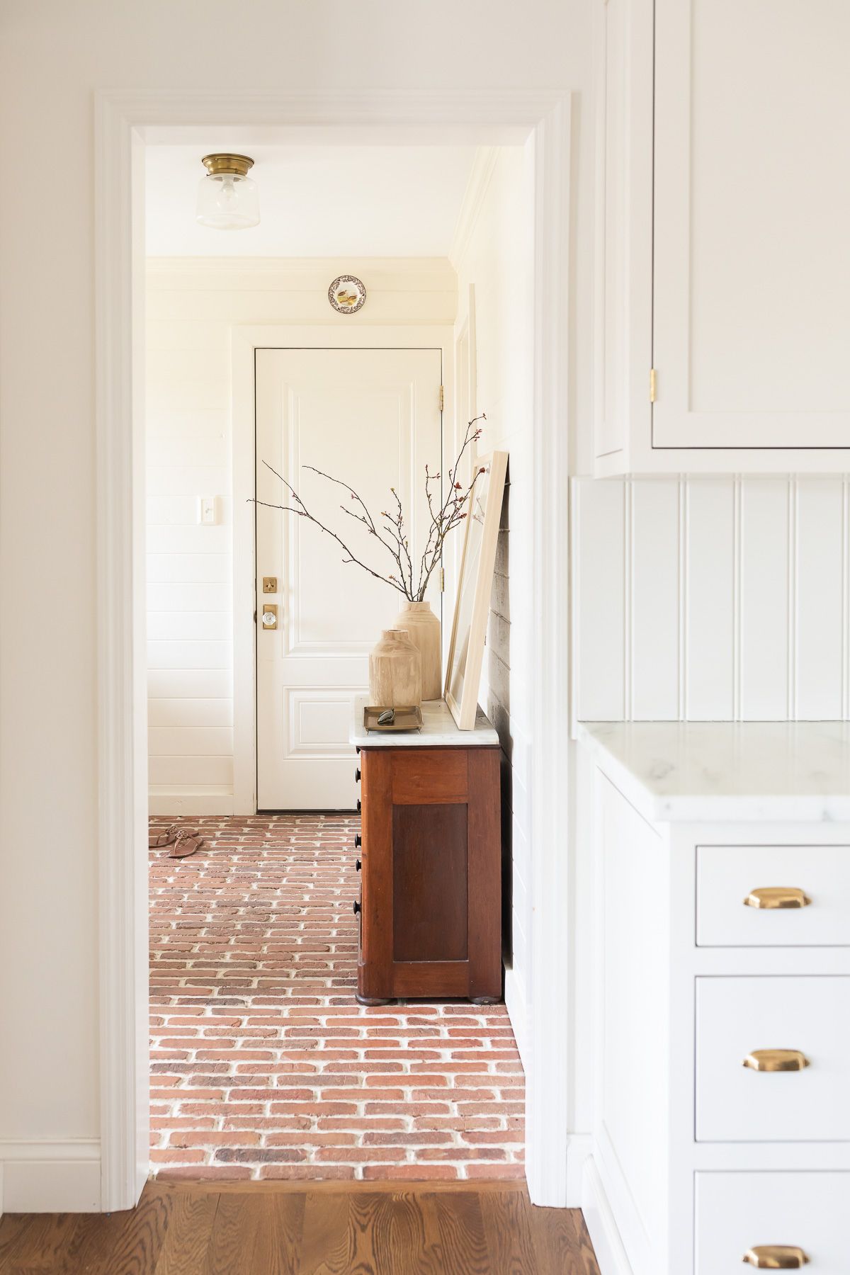 Looking into a mudroom painted in a neutral paint color, Sherwin Williams Navajo White