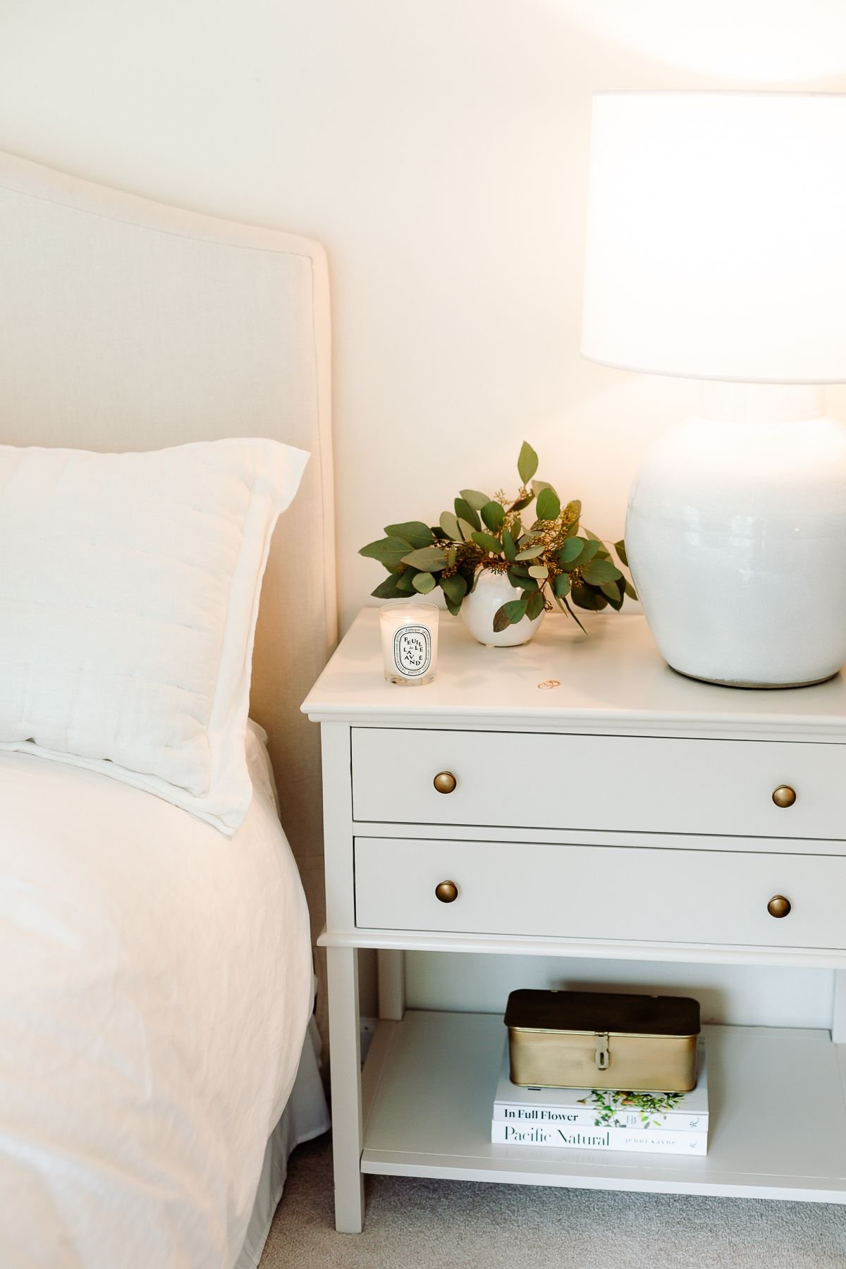 Master bedroom with white bedding and simple headboard decoration