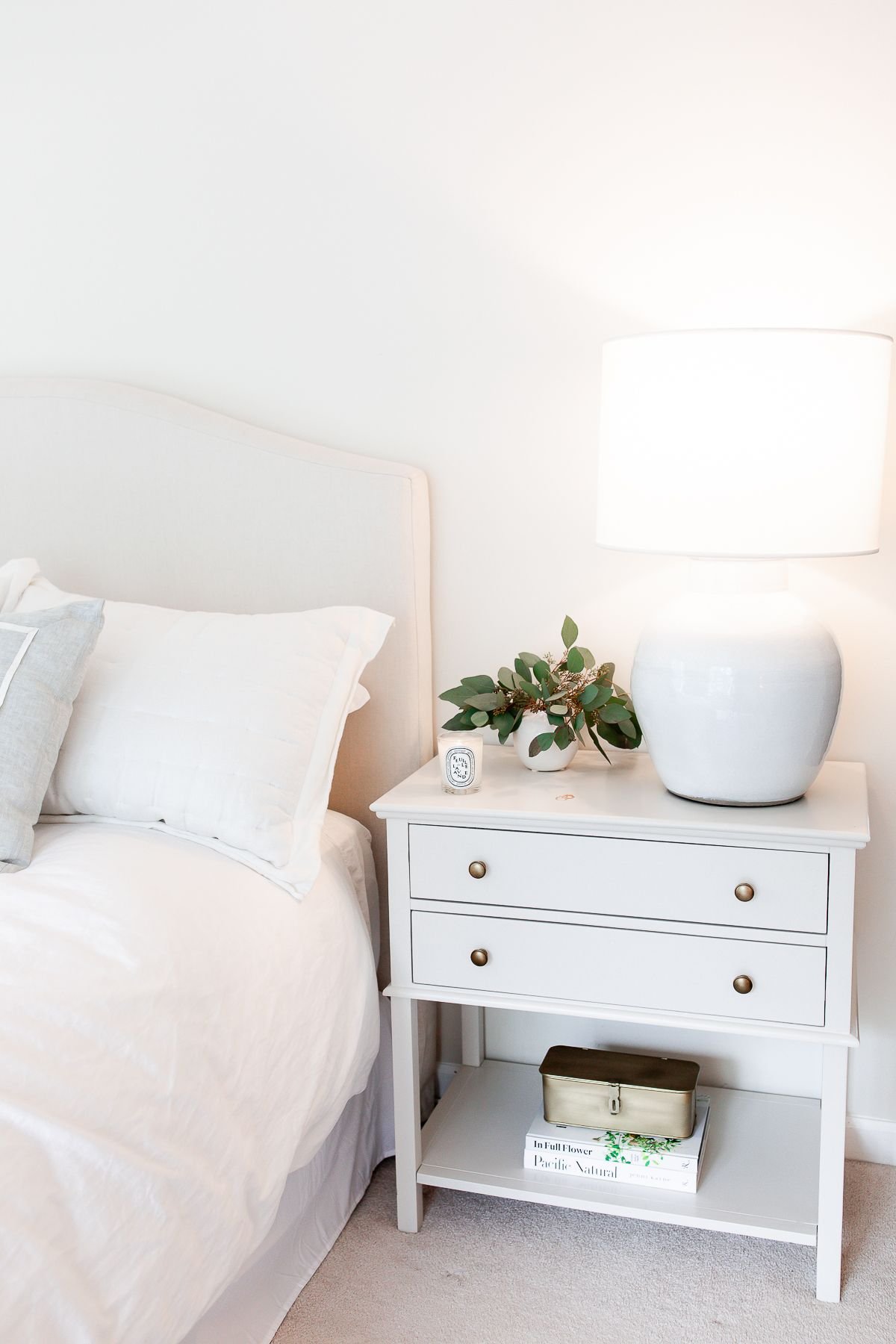 Nightstand decor in a cream bedroom