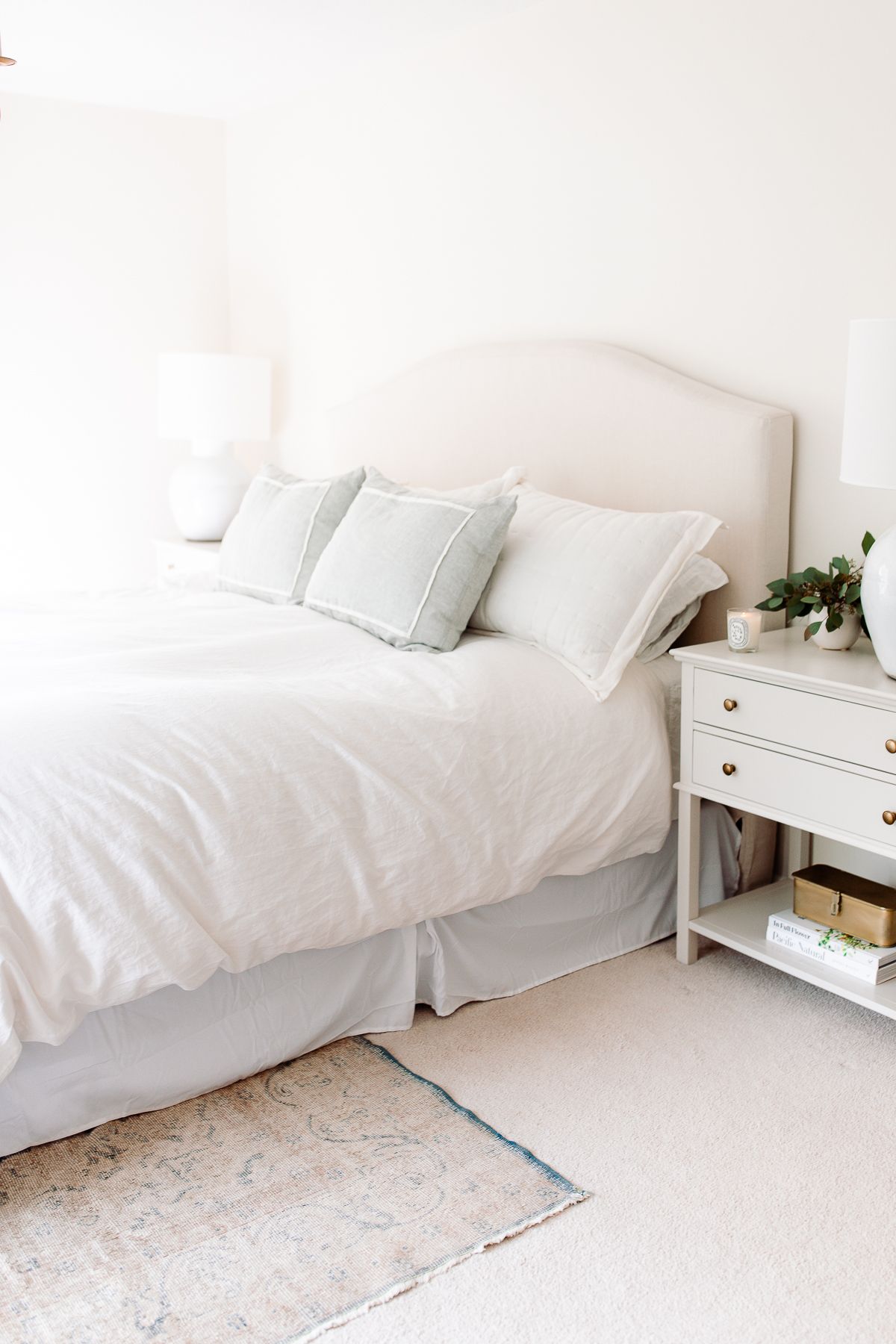 Master bedroom with white bedding and simple headboard decoration