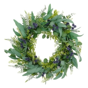 This spring wreath features eucalyptus leaves and vibrant purple flowers.