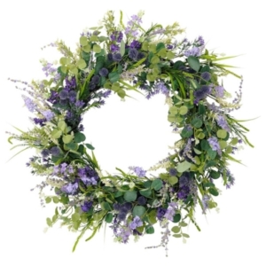 A spring wreath with purple flowers and green leaves.