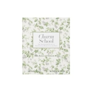 The book "Charm School," perfect for nightstand decorating, features a white cover with a green floral pattern and text by Emma Bazilian and Stephanie Diaz, published by Monacelli and Schumacher.