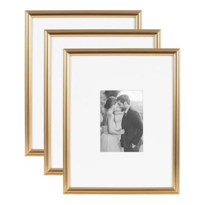 Three gold picture frames are displayed, with a black-and-white photo of a couple in the center frame—ideal for showcasing your favorite Amazon art prints.