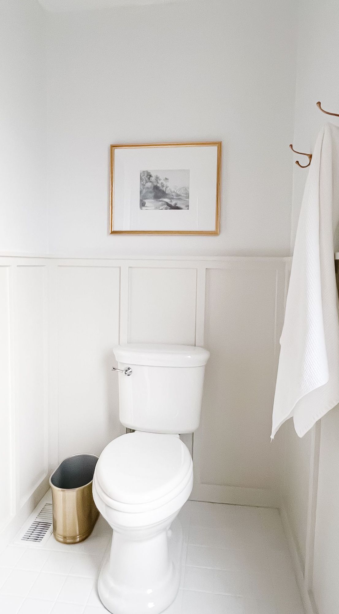 A white and gray bathroom with a sink surrounds the space and painted white by the decorator above.