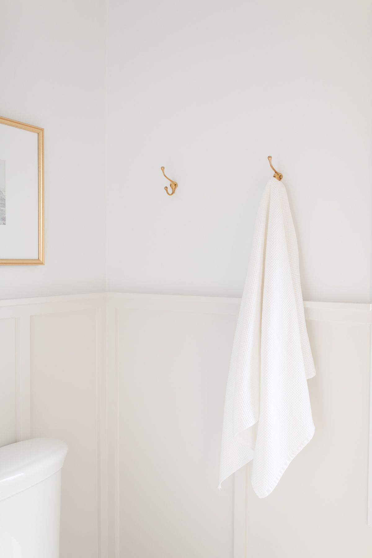 Bathroom with gray walls at the bottom and white walls by BM Decorator at the top.