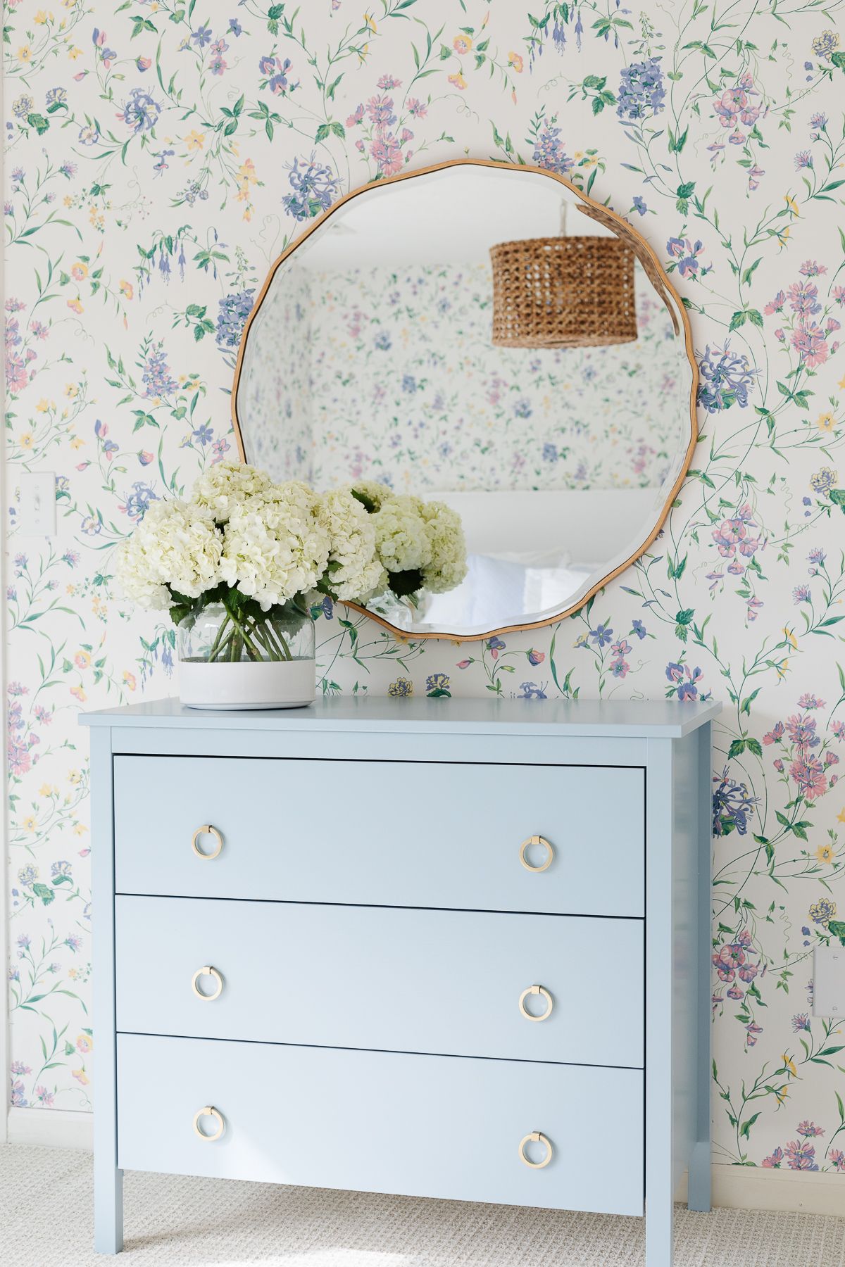 Bedroom with floral wallpaper and wardrobe painted in Blue