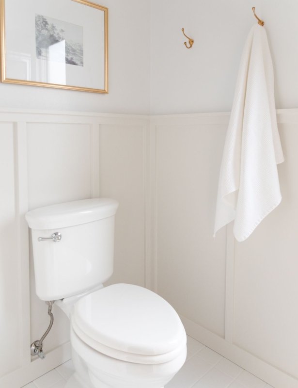 A bathroom with light gray board and batten