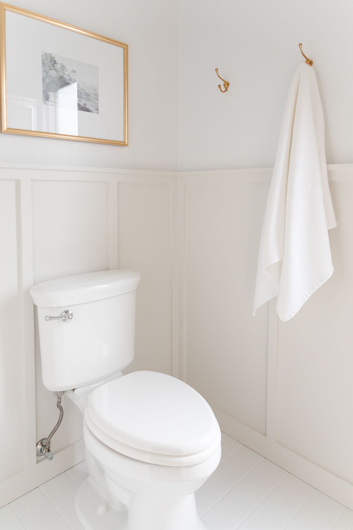 A bathroom with light gray board and batten