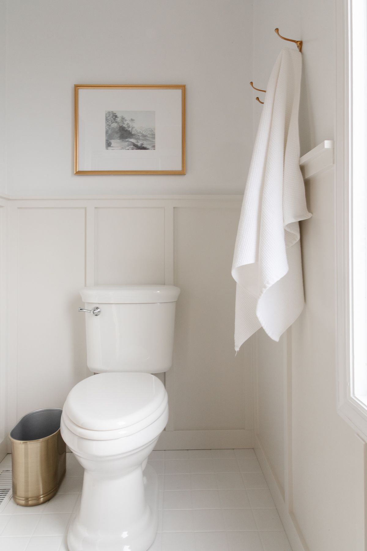 A bathroom with light gray board and batten