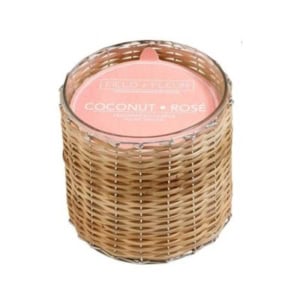 A round candle labeled "Coconut Rosé" in a glass container wrapped with a light brown wicker basket—perfect for nightstand decorating.
