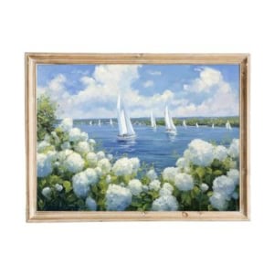 Painting of sailboats on a blue lake with white flowers and green foliage in the foreground, framed in light wood—an elegant addition to your space and a perfect find for those seeking amazon art inspiration.