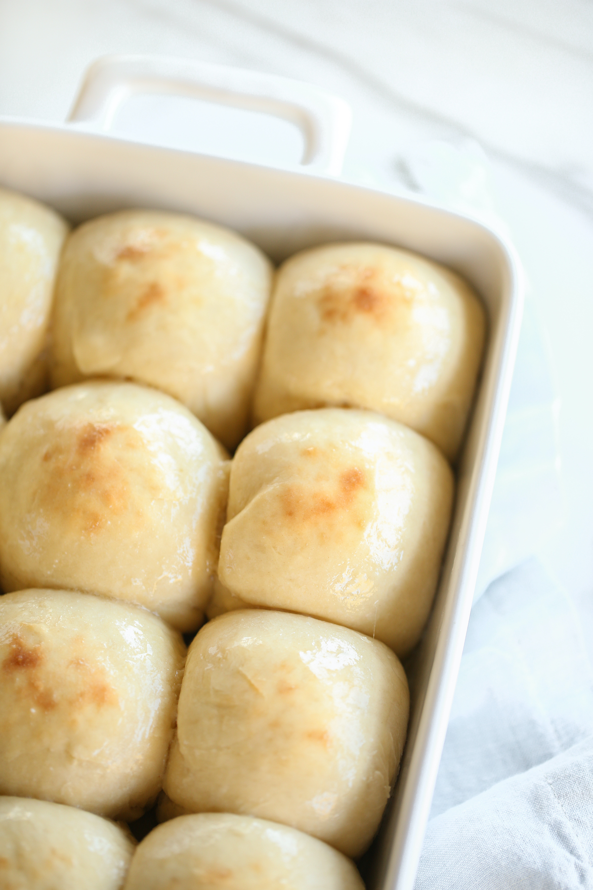 Easter side dishes: Bread rolls in a white baking dish.