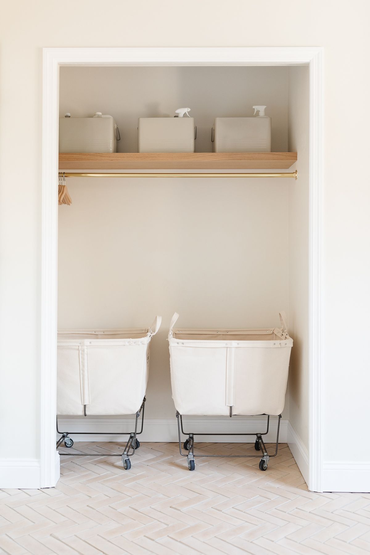 Laundry room with closet and herringbone tiled floor