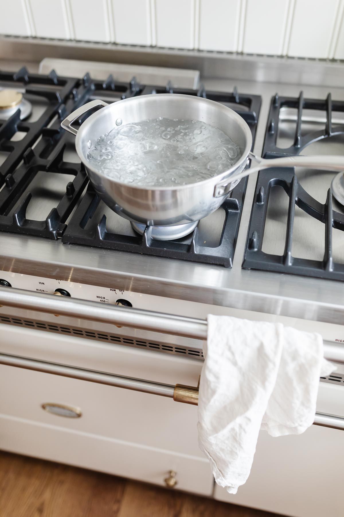 Boiling water in pan. Cooking pot on stove with water and steam