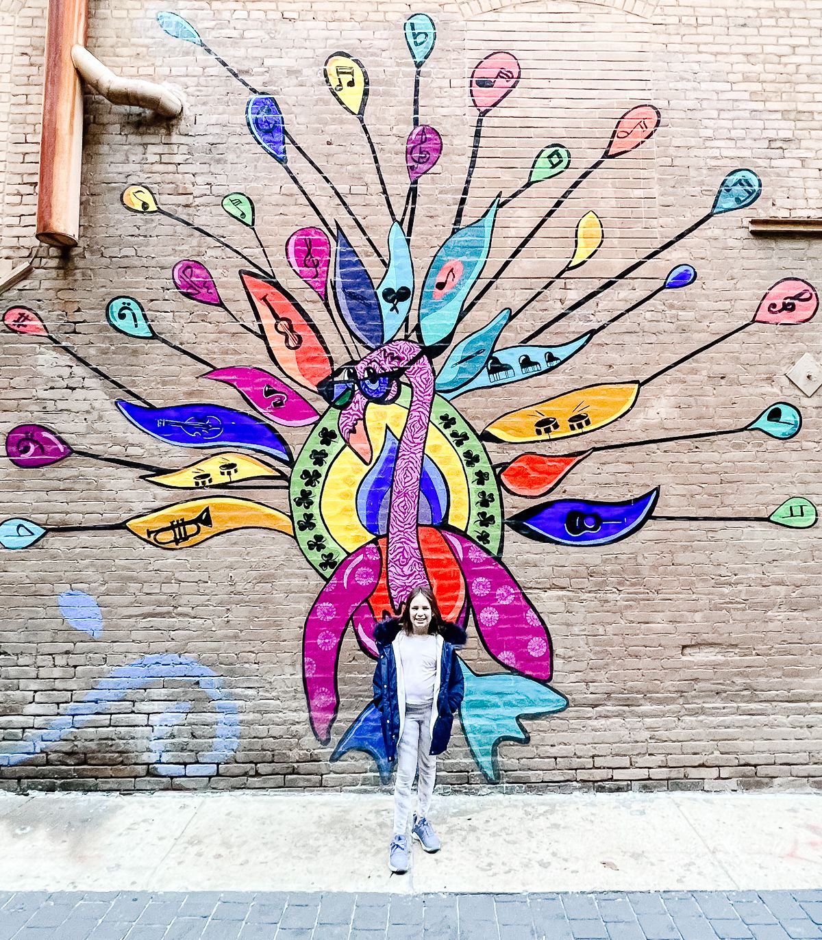 A little girl in front of a colorful mural in Memphis