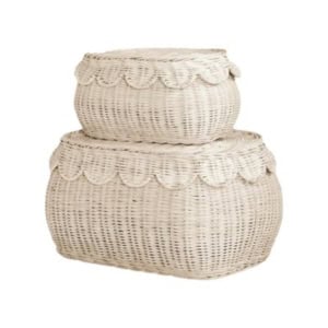 Two white woven wicker storage baskets with scalloped edges, one stacked on the other, perfect for nightstand decorating against a plain background.