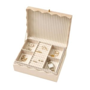 A beige jewelry box with a striped interior is perfect for nightstand decorating, keeping your gold rings, pearl earrings, and watch beautifully organized in separate compartments.