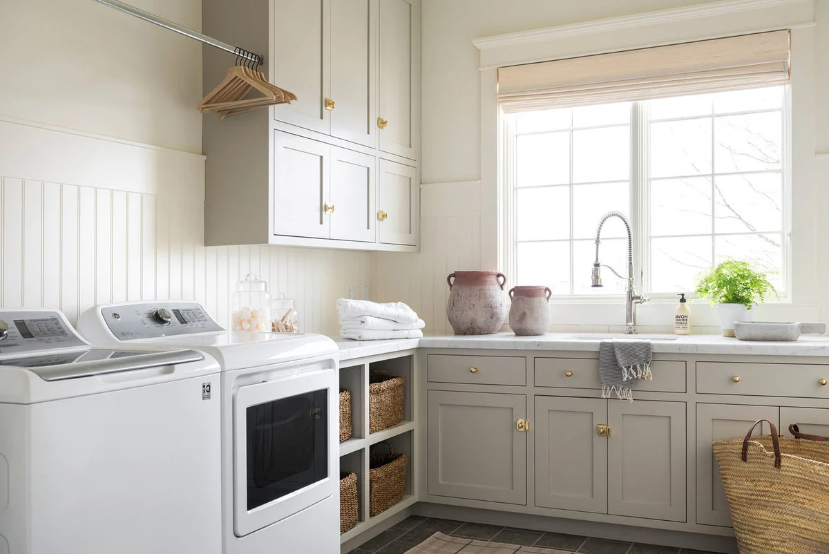 A laundry room with cabinets painted in Benjamin Moore Revere Pewter. 